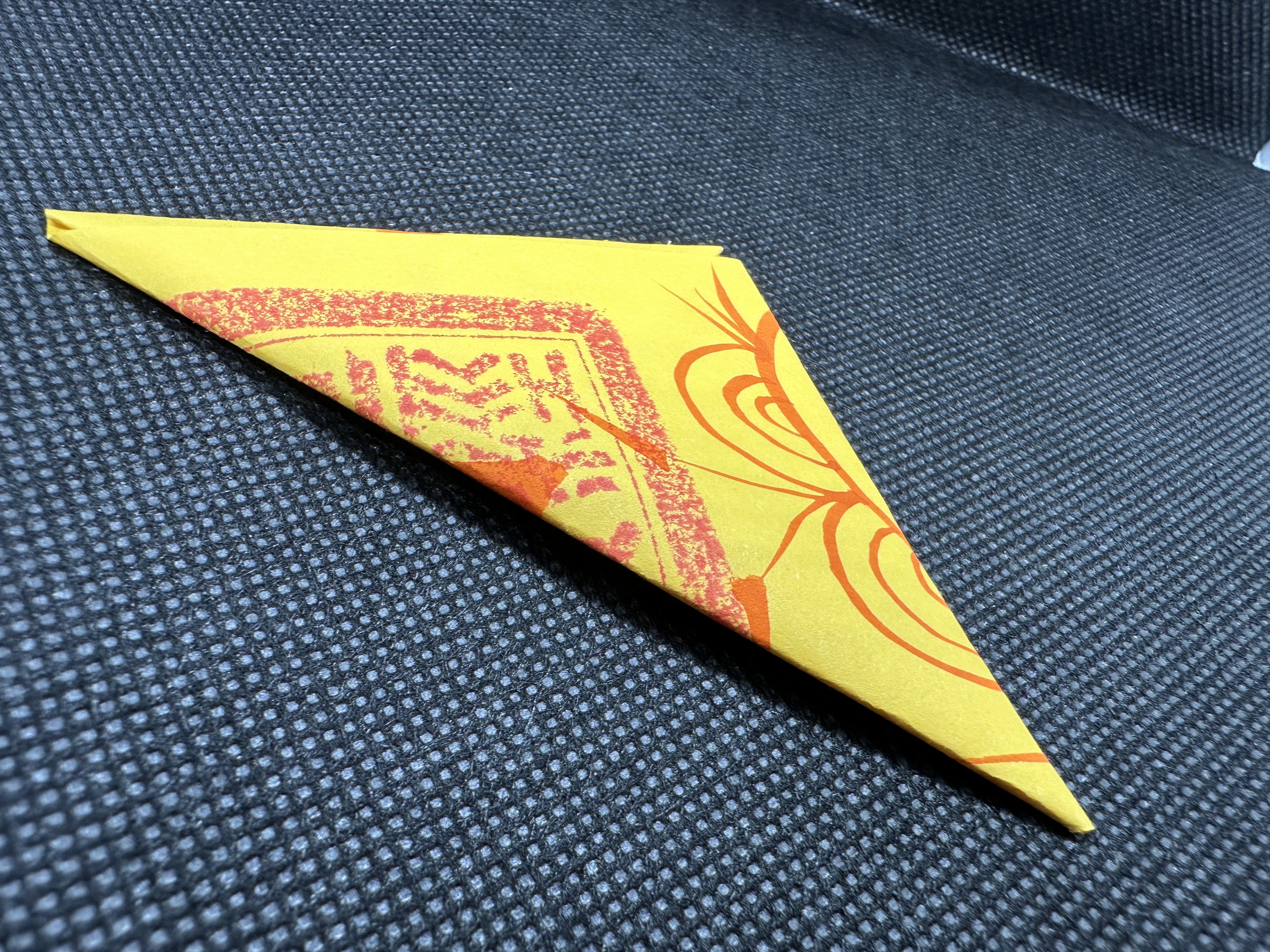 Folded hand-drawn Zhong Kui inspired talisman artwork on dark textile